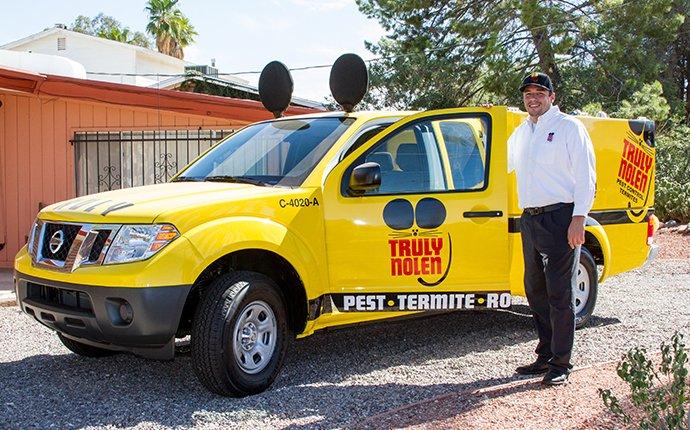 man in front of pest control truck